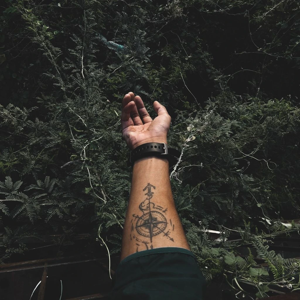 Geometric atlas compass tattoo on chest, symmetrical linework with dotwork shading