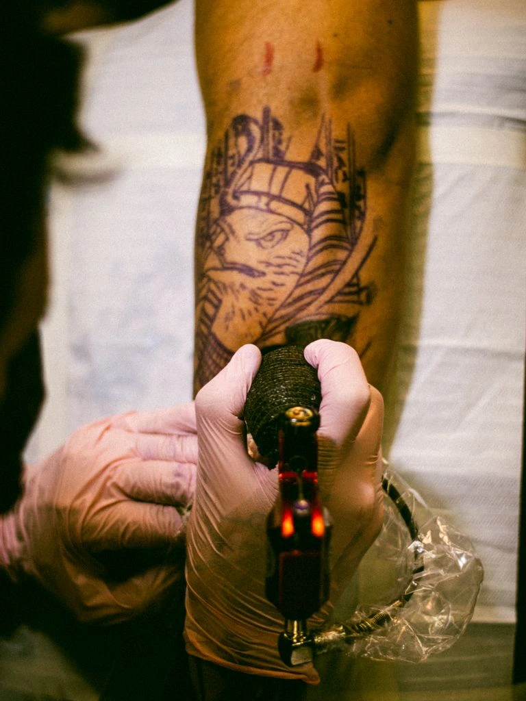 Forearm fine-line wildflower tattoo, this week's drop